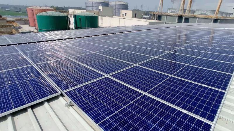Grid-tied solar modules installed across an industrial rooftop in Bangladesh